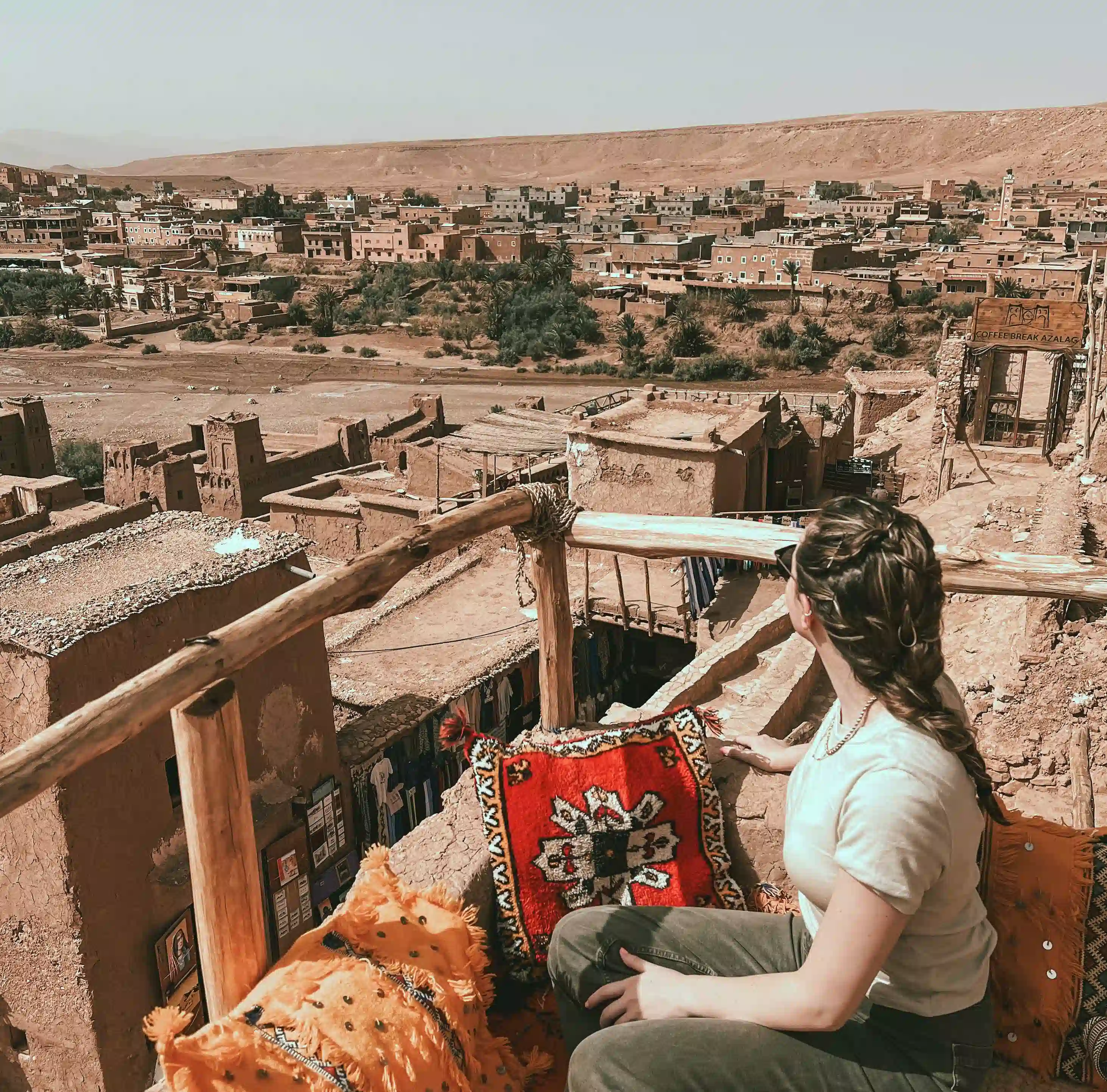 Girl sitting in a cafe in Ait Ben Haddou overlooking the village on the other side.