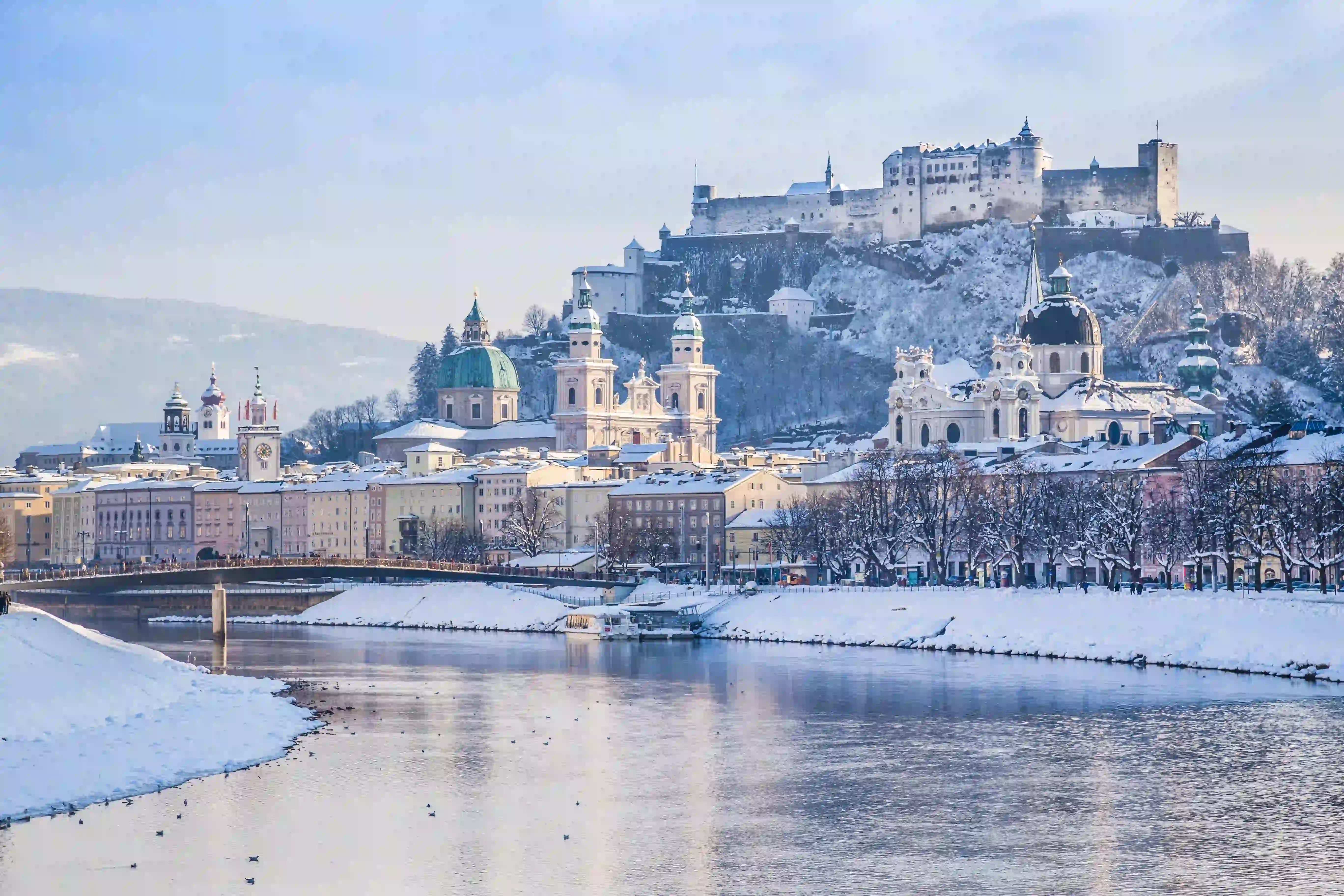 Overlooking snow-covered Salzburg and Fortress Hohensalzburg from the Salzach River. 