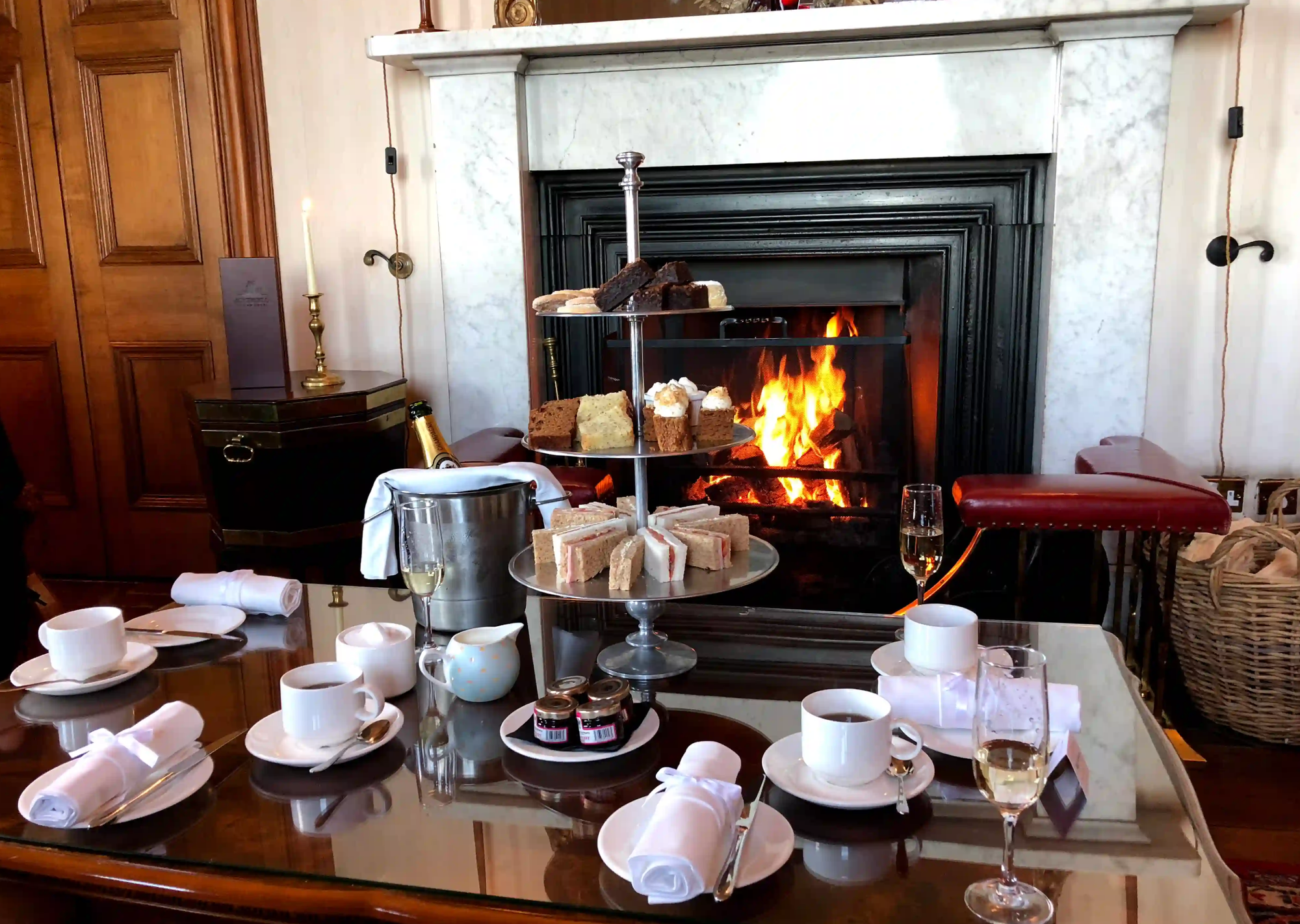 Afternoon tea with prosecco, tea and a wood fire in the background.