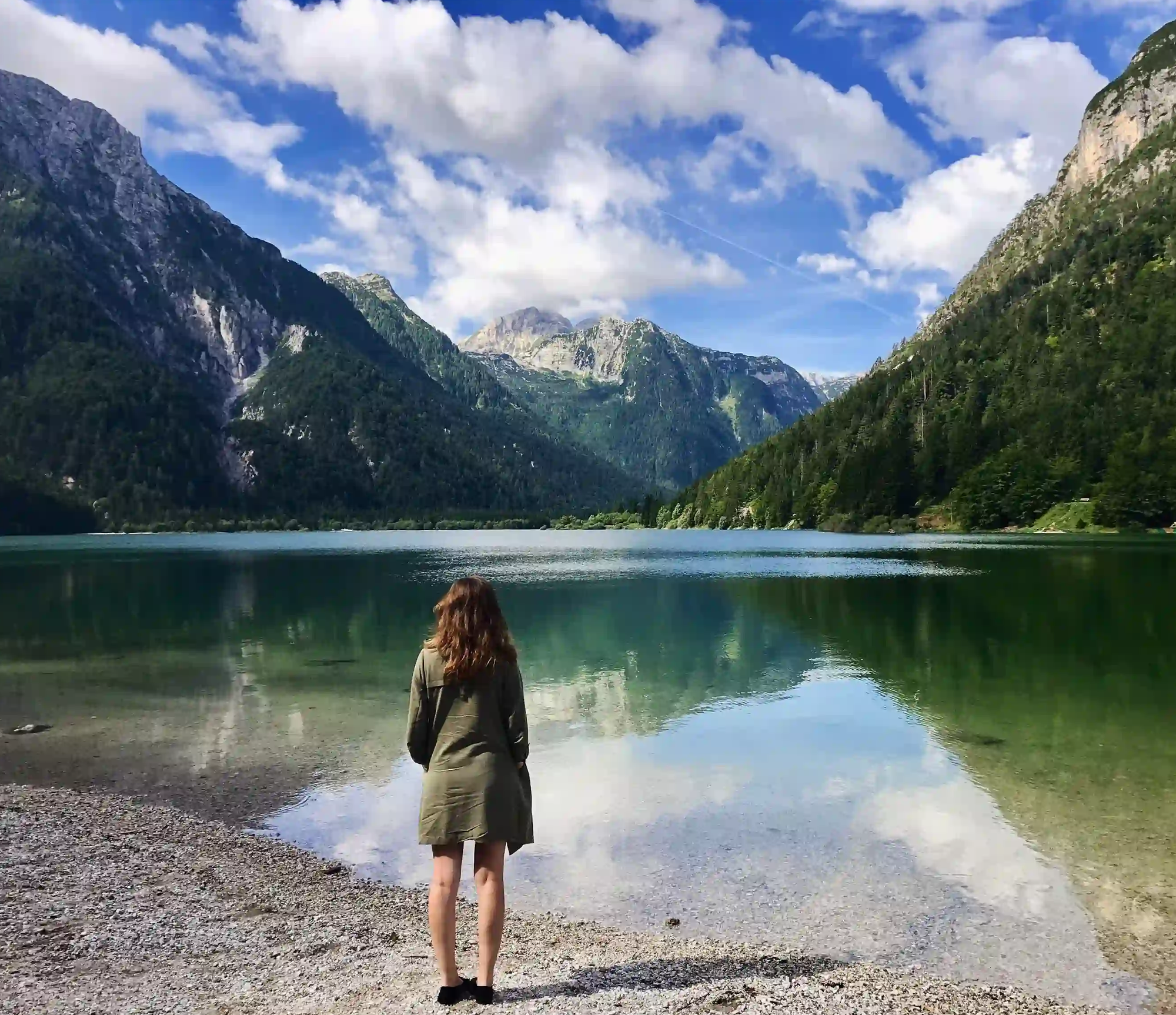 Girl standing in front of Lago del Predil in Northern Italy.