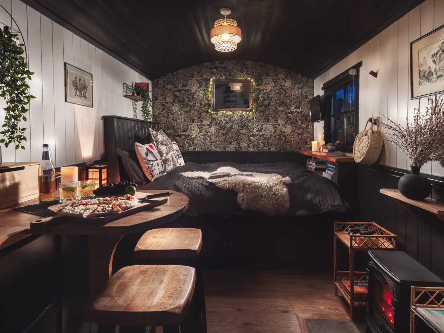 The living area with bed and dining table at the Shepherd's Zen, The Shepherd's Hut Retreat.