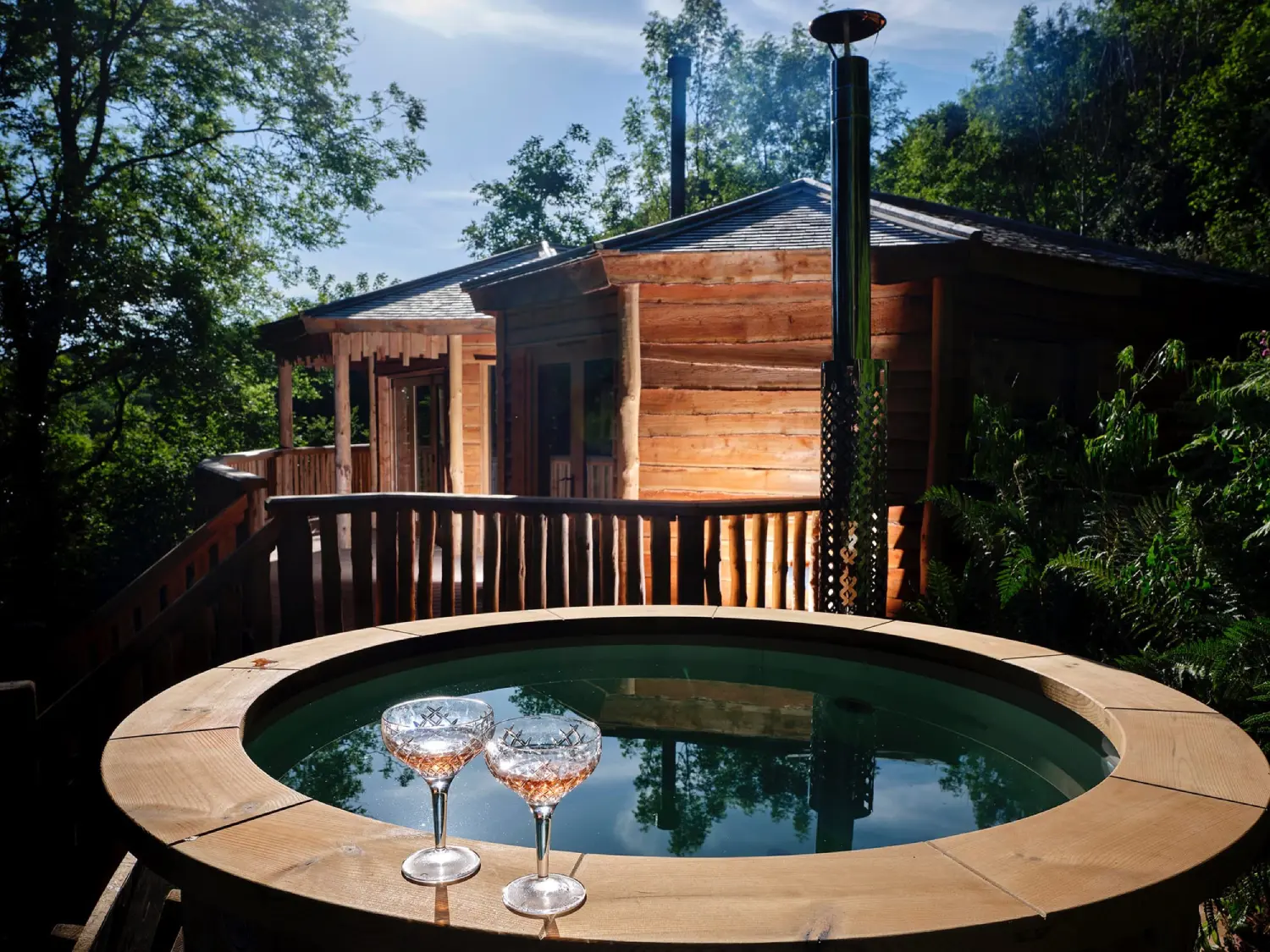 Hot Tub with glasses of prosecco on the side at Hideout Treehouse, Sleepy Owl Retreats Devon.