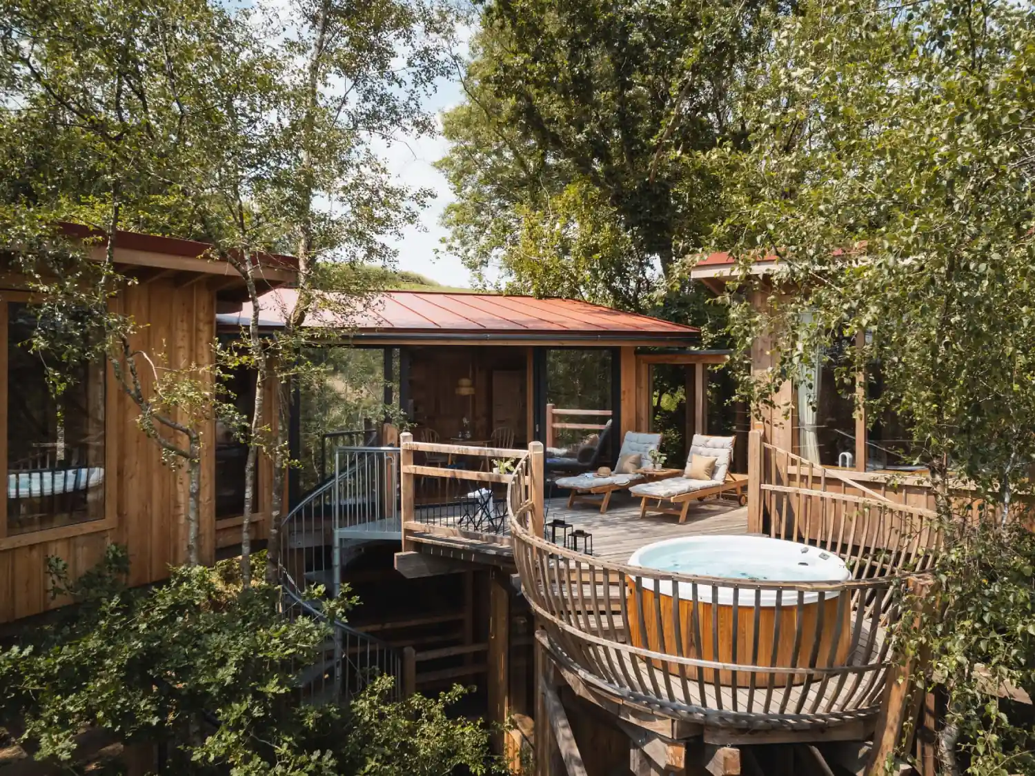 The Spa Exterior showing the hot tub and decking area at Wolf Wood Treehouses.