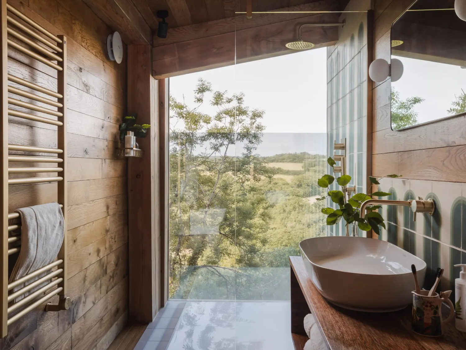 Shower with full length window overlooking the countryside.