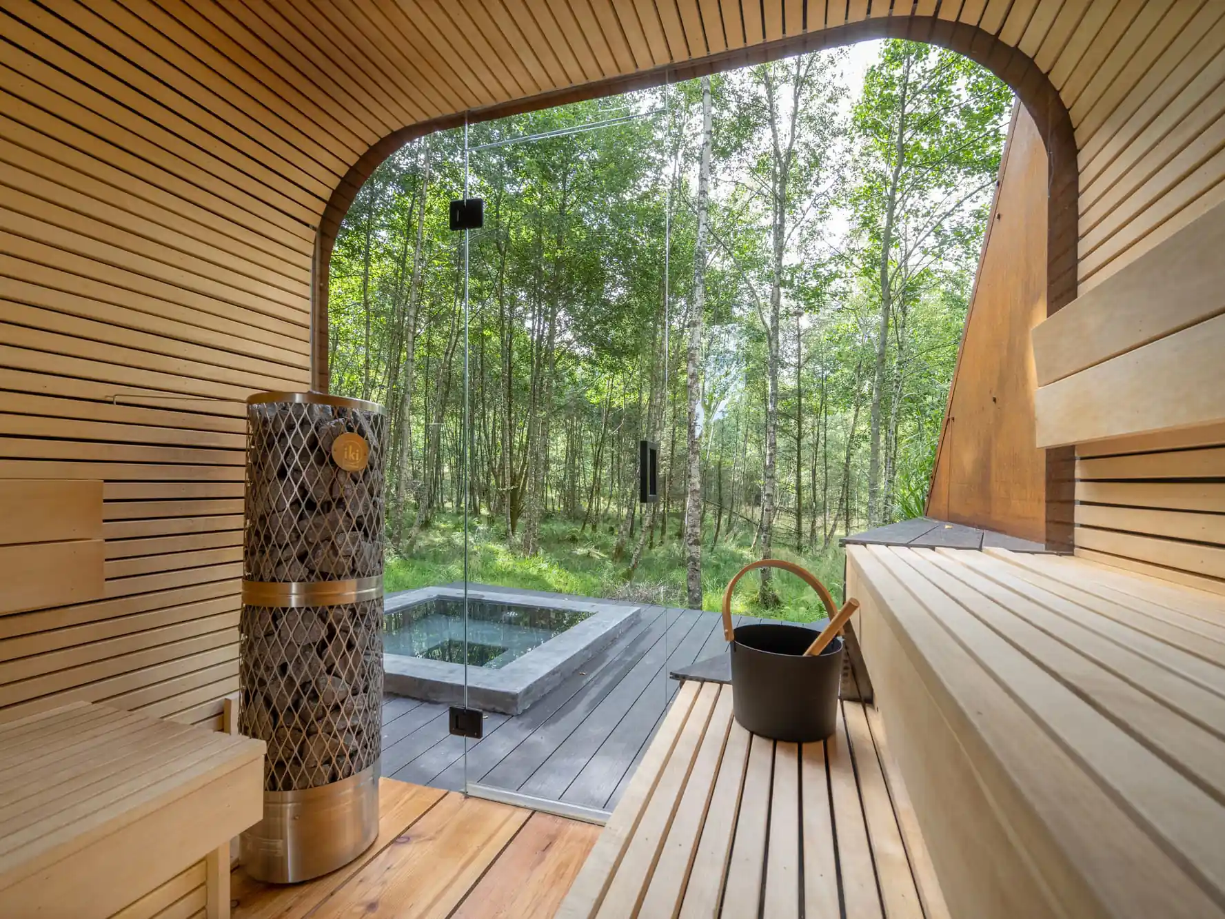 Sauna and plunge pool surrounded by woodland at Treehouses at Lanrick.