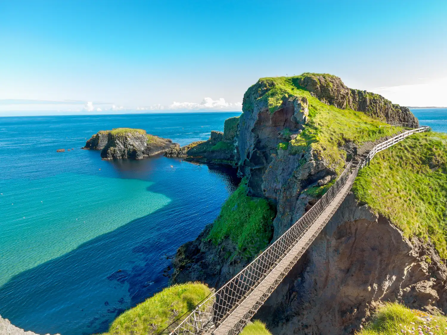 View over Carrick-a-Rede Bridge, rocks and sea on the Causeway Coastal Route, Northern Ireland.