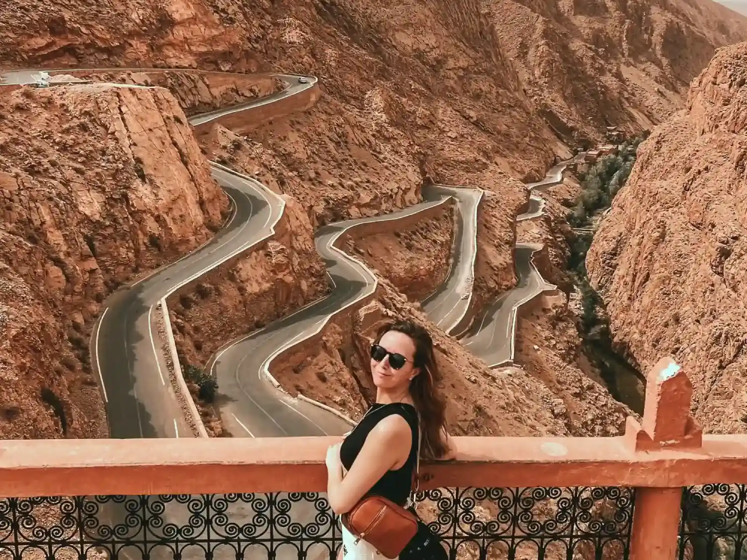 Girl standing at Tisderine Bends in Dades Valley viewpoint.