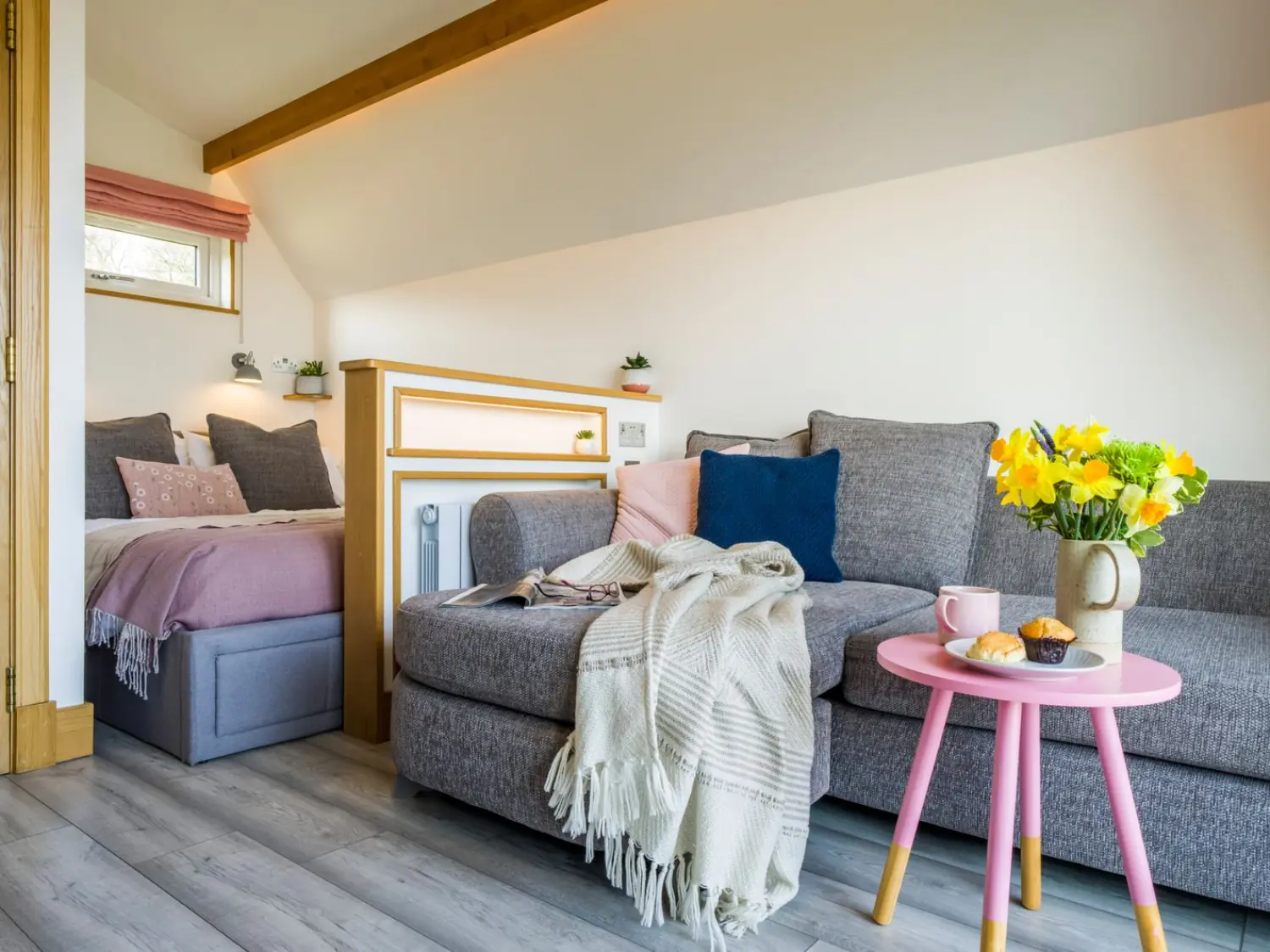 Inchmurrin Bonnie Barn Interior with corner sofa and double bed.