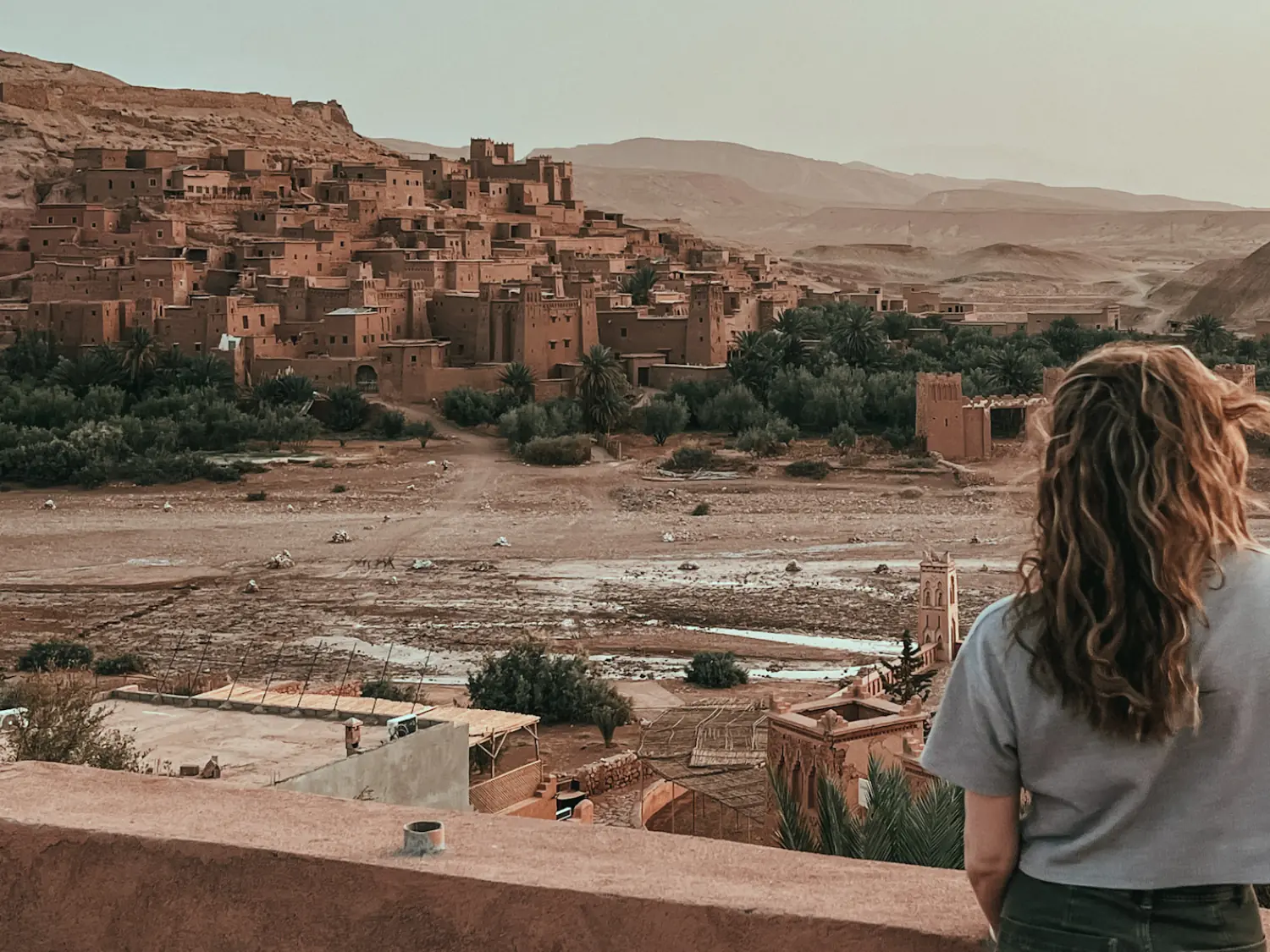 Girl watching the sunrise over Ait Ben Haddou.