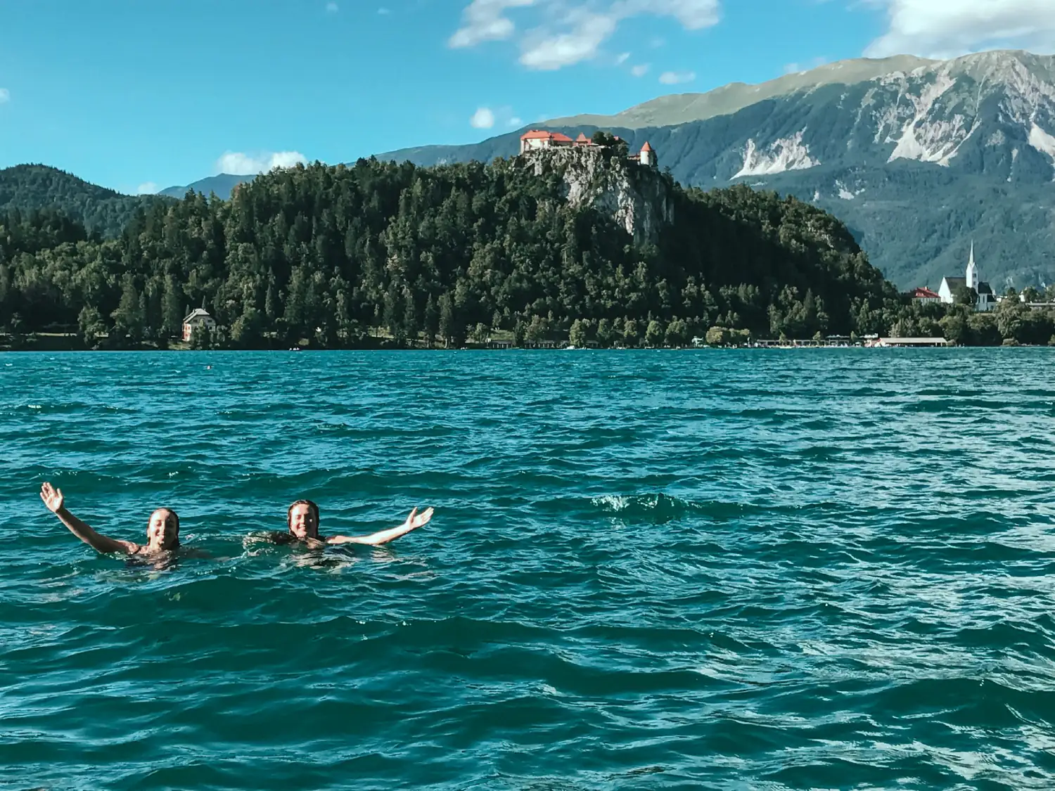 Two girls in the water at Lake Bled in Slovenia.