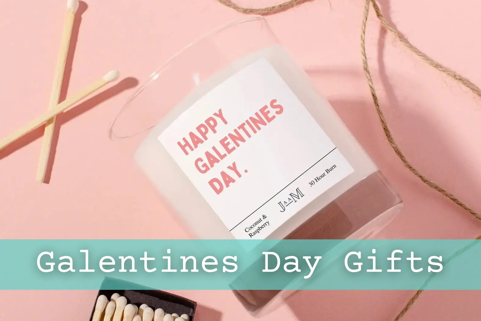 'Happy Galentines Day' candle against pink backdrop with matches and twine.