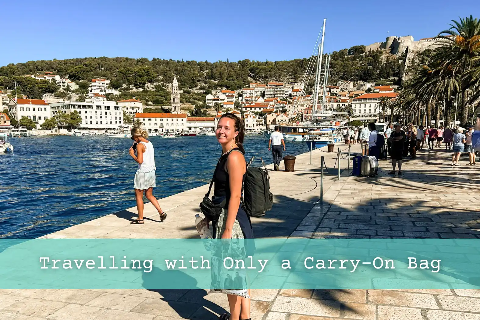 Girl in Hvar Croatia with a carry-on backpack and multiple bags. 